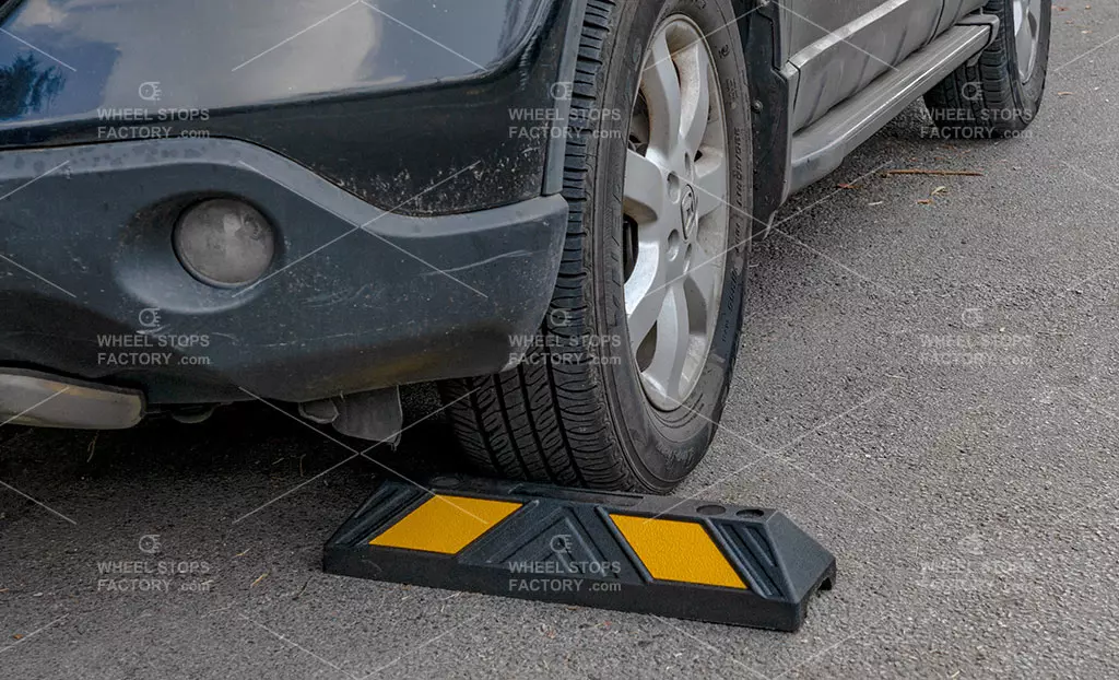 A car stop used in a parking space as a parking management device