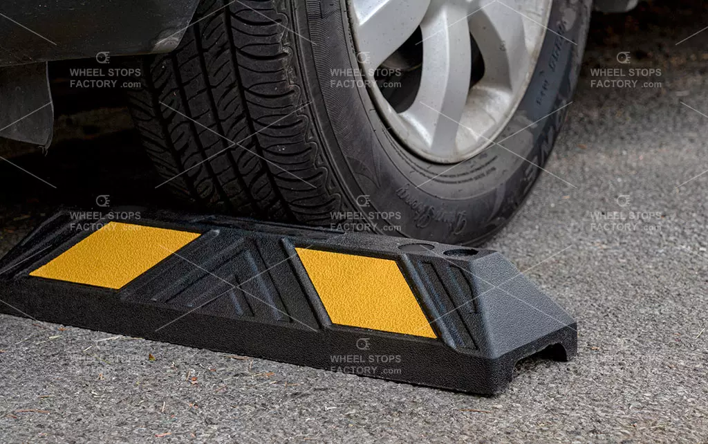 A black and yellow parking stop to help driver park vehicles correctly