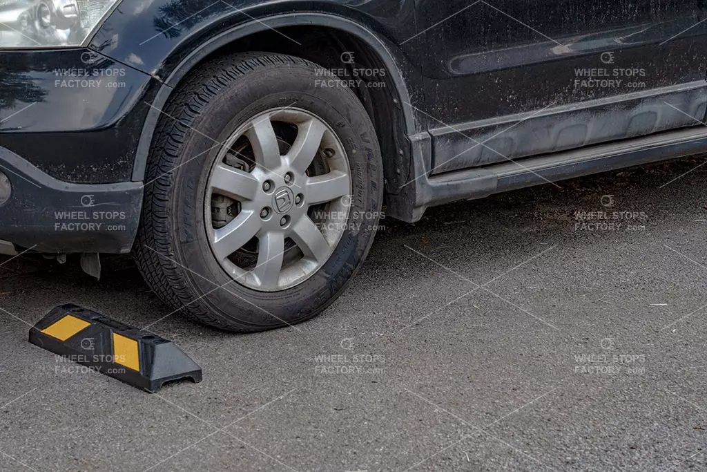 A car parking in the parking space near the black and yellow car stops