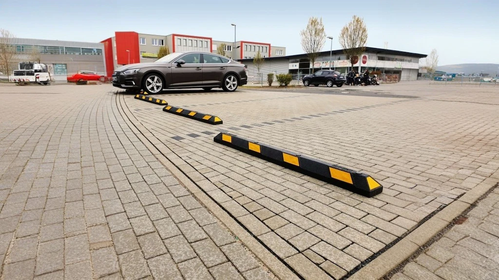 A couple of Park-aid wheel stops placed in the parking lots as car park tools