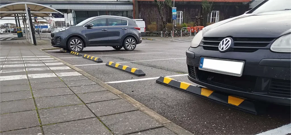 Black and yellow wheel stops for parking lots.